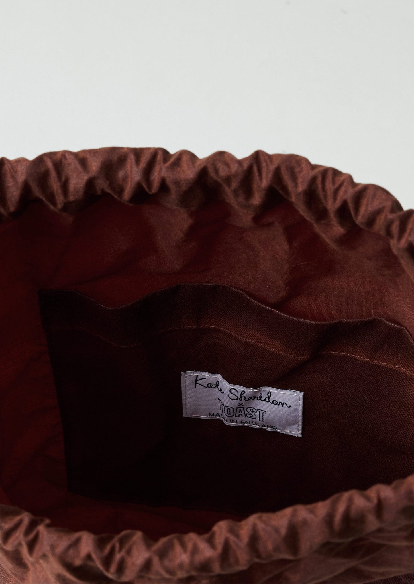 Zaino con fiocco in cotone cerato Kate Sheridan | Castagna